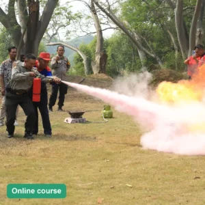 Trainee putting out a controlled training fire with a fire extinguisher (online course)